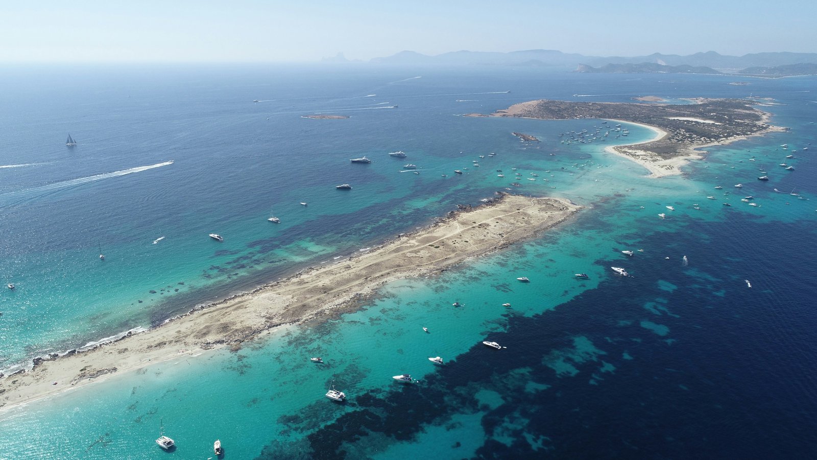 Wide aerial view of Formentera and turquoise water from above