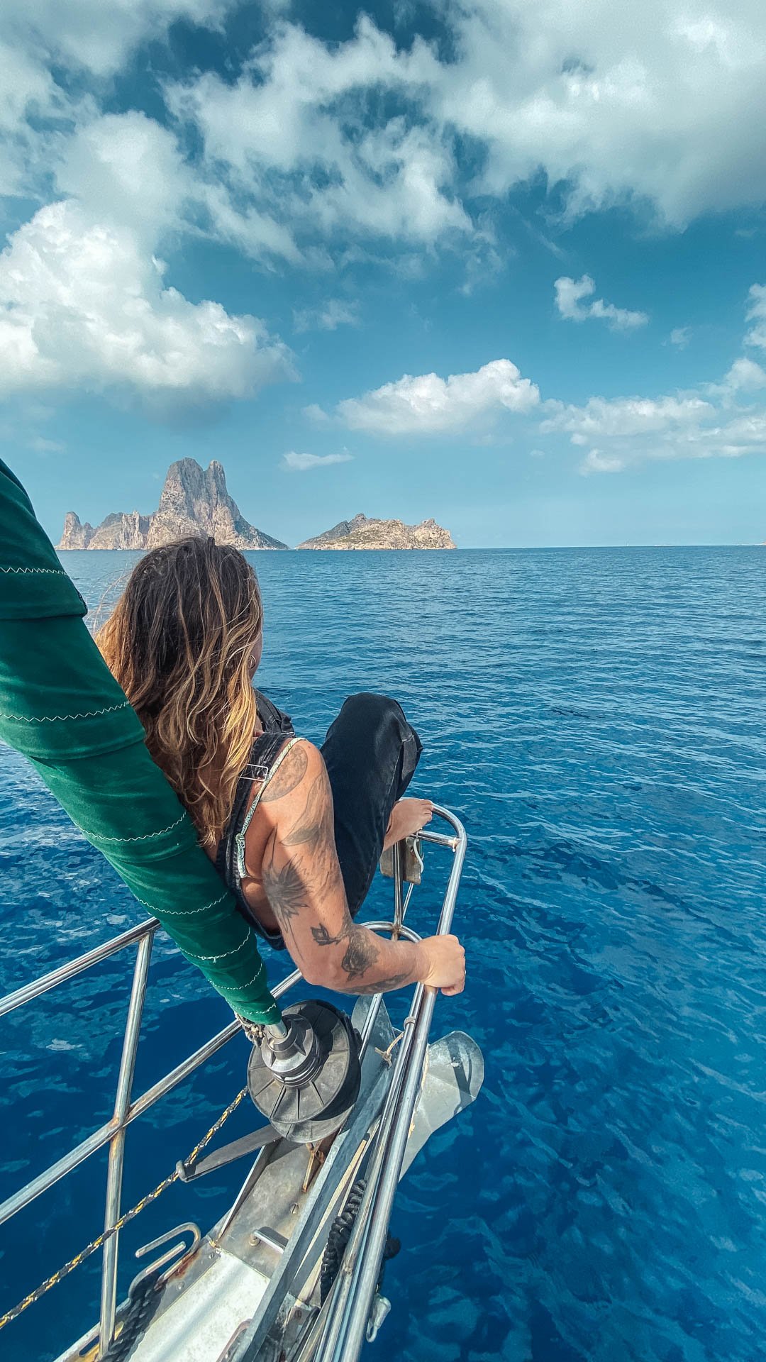 Guest enjoying the view of Es Vedra from the bow of the boat